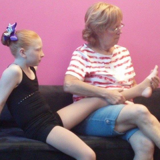My mother giving Eliza a footrub before practice